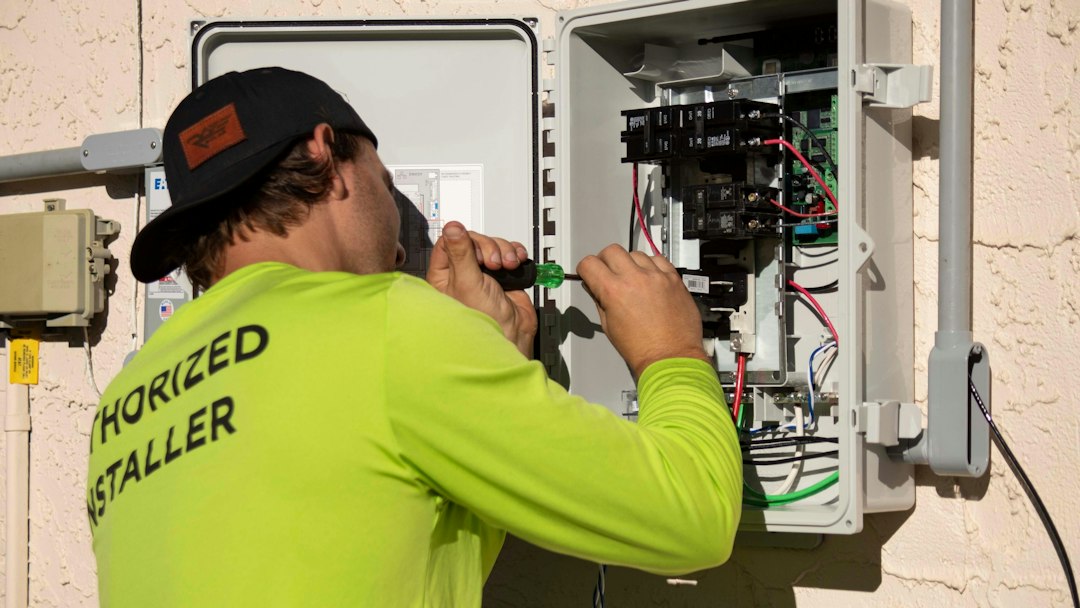 Professional electrician working on an electrical panel